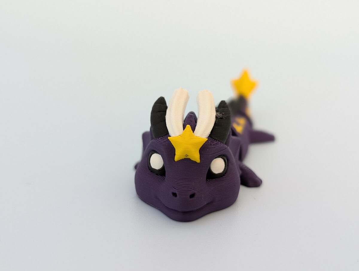 Starlight Dragon Keychain Figure facing the Star